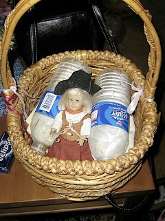 Mini Kit in a pirate outfit in a basket with a couple water bottles