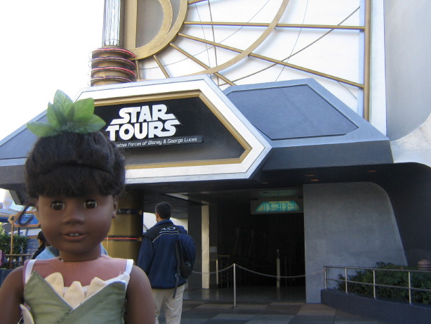 May in her Tiana dress in front of Star Tours