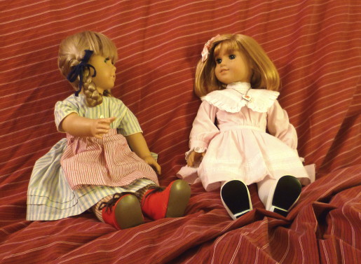 Kirsten, in her light-blue striped summer dress and Meet apron, stares at Nellie, who's in her pink Spring dress