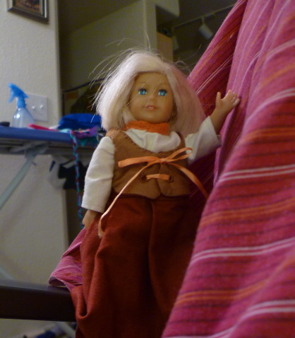 Mini Kit in her brown Renaissance Festival style bodice and skirt is up on the side of the futon