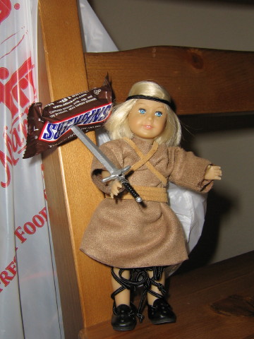 Mini Kit appears with a Snickers speared on her sword.