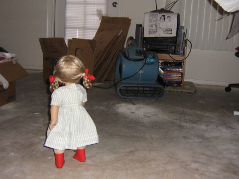Kirsten surveys the empty floor with a fan by the doll-sized TV.