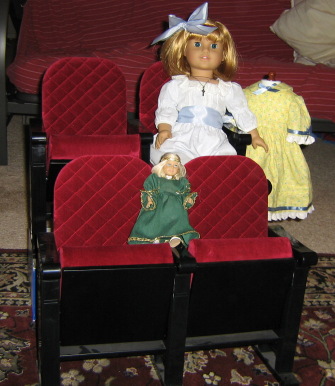Movie seats are set up--two in front, two elevated behind--with Nellie, Mini Kit, and Pegleg Sally sitting in them.