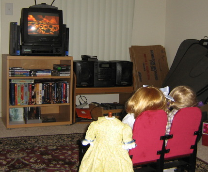The girls finally watch the movie. There are skulls on the screen.
