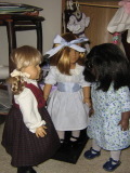 Kirsten (in her dirndl outfit) and May stare each other down while Nellie watches.